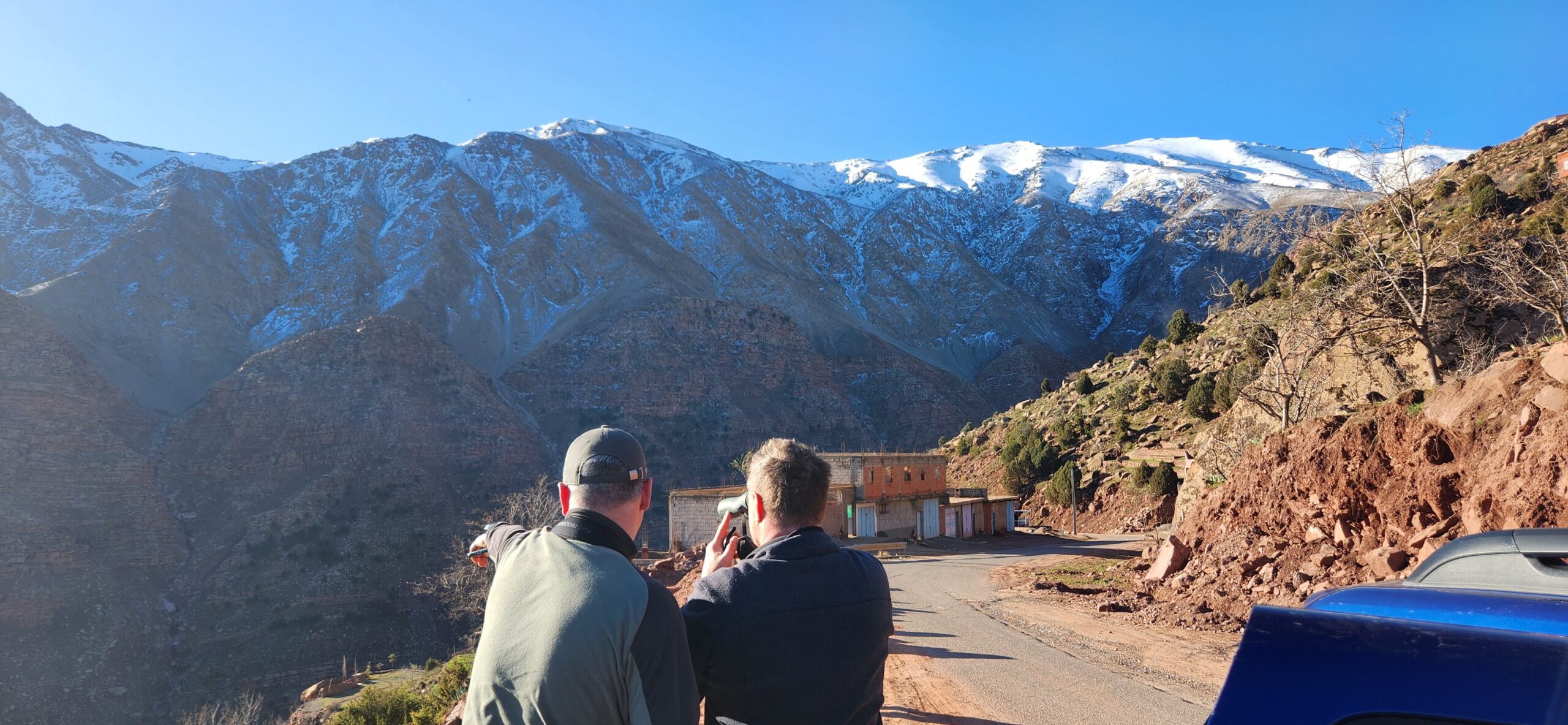 Two birdwatchers using the Trip Tick birdwatching app to spot birds in the Atlas mountains
